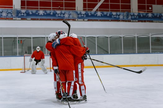 hockey players celebrating a goal after a successful faceoff